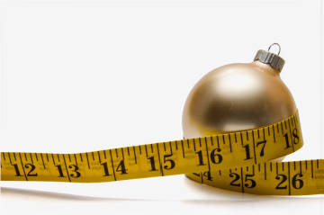 Tape measure wrapped around a Christmas ornament